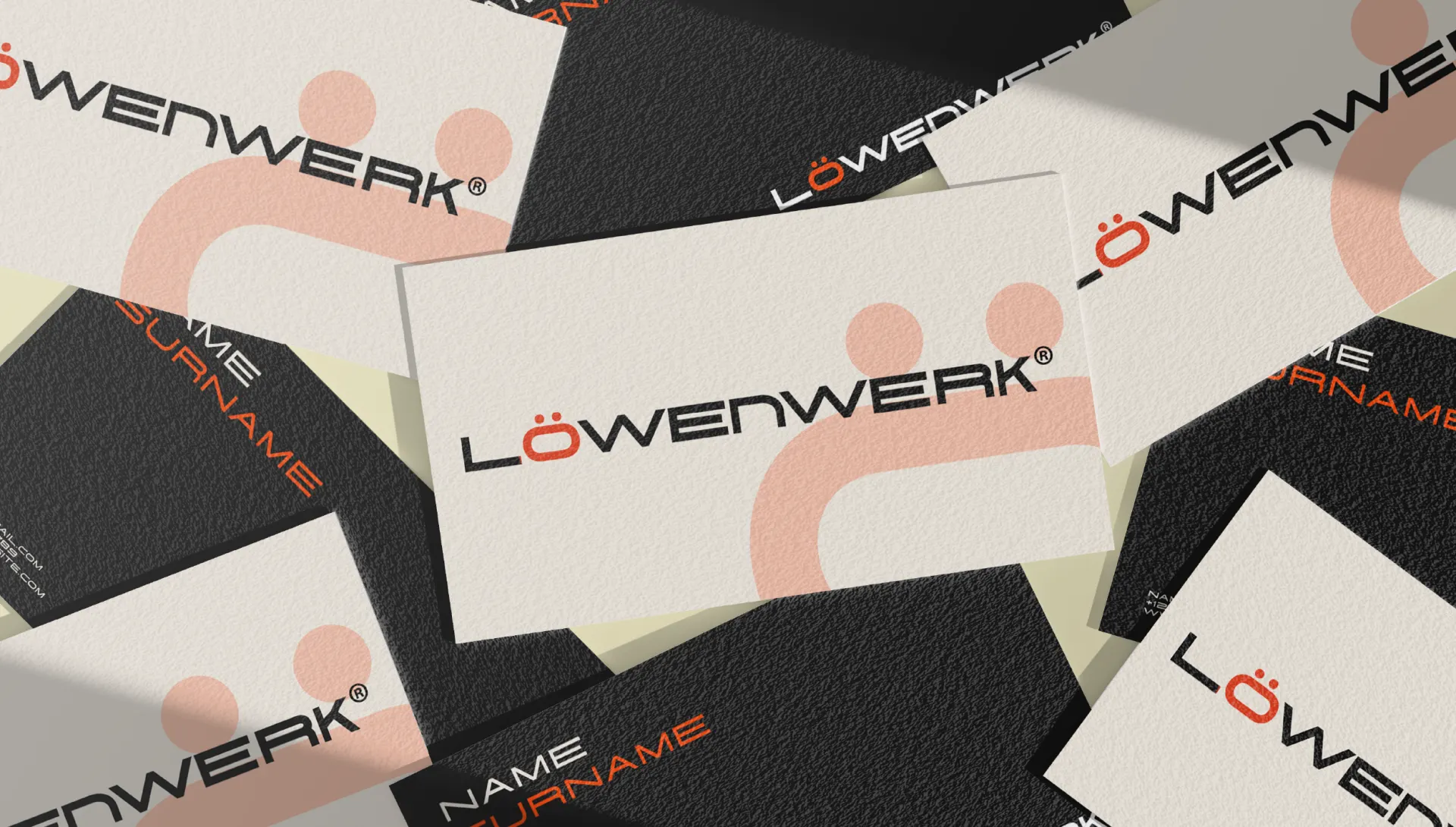 Löwenwerk business cards in black and off white, scattered face up