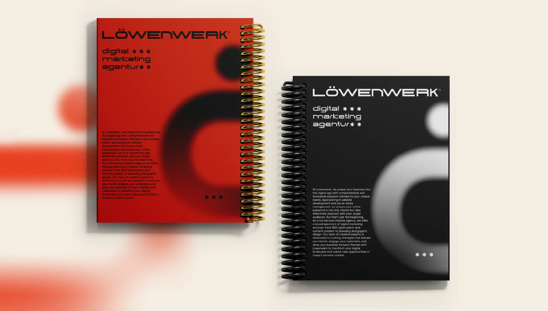 Two spiral bound Löwenwerk brochures, one red and one black