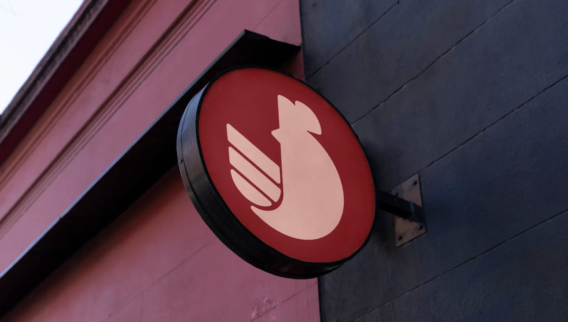 The Wings chicken mark on a round projecting sign outside the shopfront